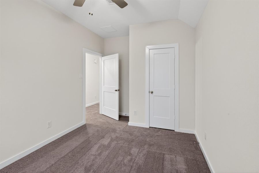 Bright and inviting bedroom with a ceiling fan and peaceful backyard views, creating a relaxing atmosphere. Bright and inviting bedroom with a ceiling fan and peaceful backyard views, creating a relaxing atmosphere.