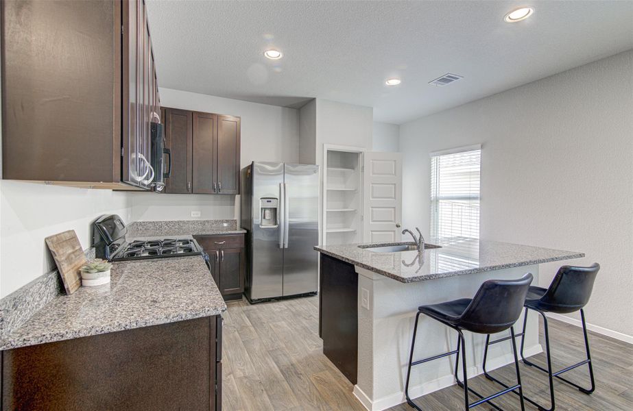 Modern kitchen with granite countertops and stainless steel appliances awaits culinary adventures. Modern kitchen with granite countertops and stainless steel appliances awaits culinary adventures.