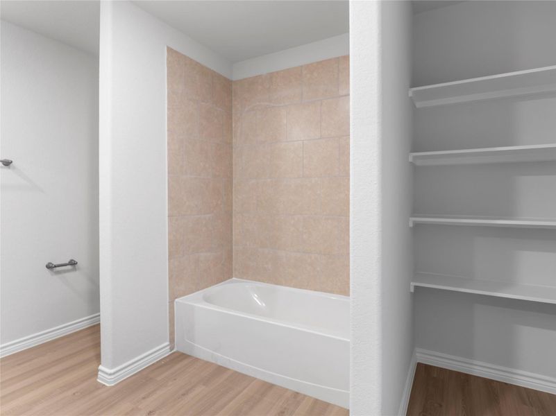 Upstairs master bath featuring built-in shelves and a separate tub for ultimate relaxation. Upstairs master bath featuring built-in shelves and a separate tub for ultimate relaxation.