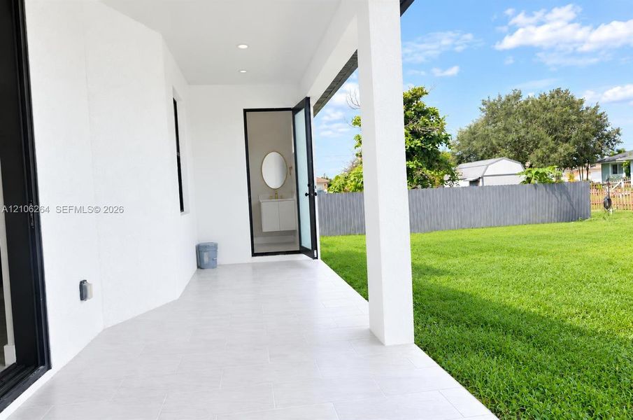 Covered patio featuring light-toned tile flooring, recessed lighting, and a direct entrance to an interior space