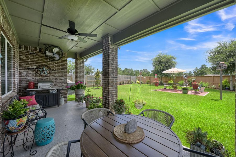 Outdoor Living Upgrades – Epoxy-coated back porch with ceiling fan and manual shade screen creates a comfortable outdoor retreat. Outdoor Living Upgrades – Epoxy-coated back porch with ceiling fan and manual shade screen creates a comfortable outdoor retreat.