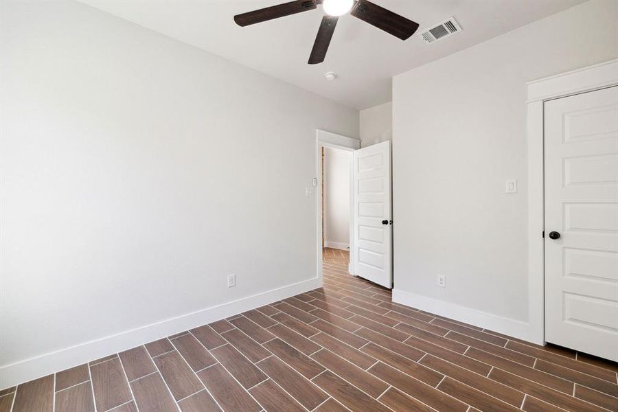 Unfurnished bedroom with ceiling fan and a closet