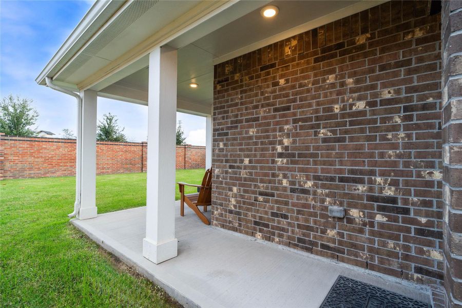Step seamlessly from the home onto this charming covered concrete patio, perfect for enjoying the peaceful backyard and connecting with the outdoors.