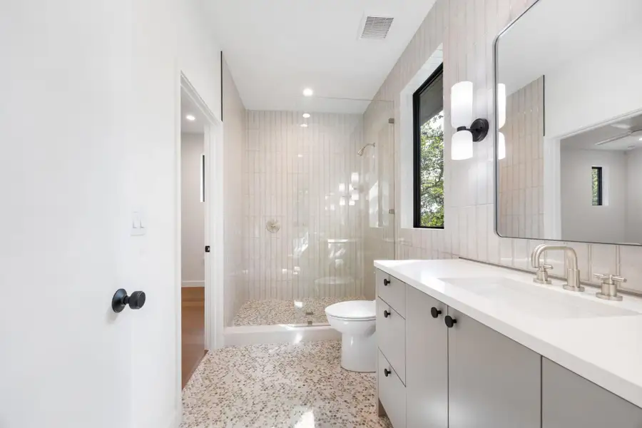 Full bathroom featuring vanity, a shower stall, and recessed lighting