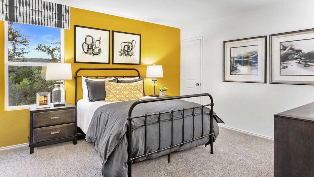 Bedroom featuring light colored carpet and baseboards