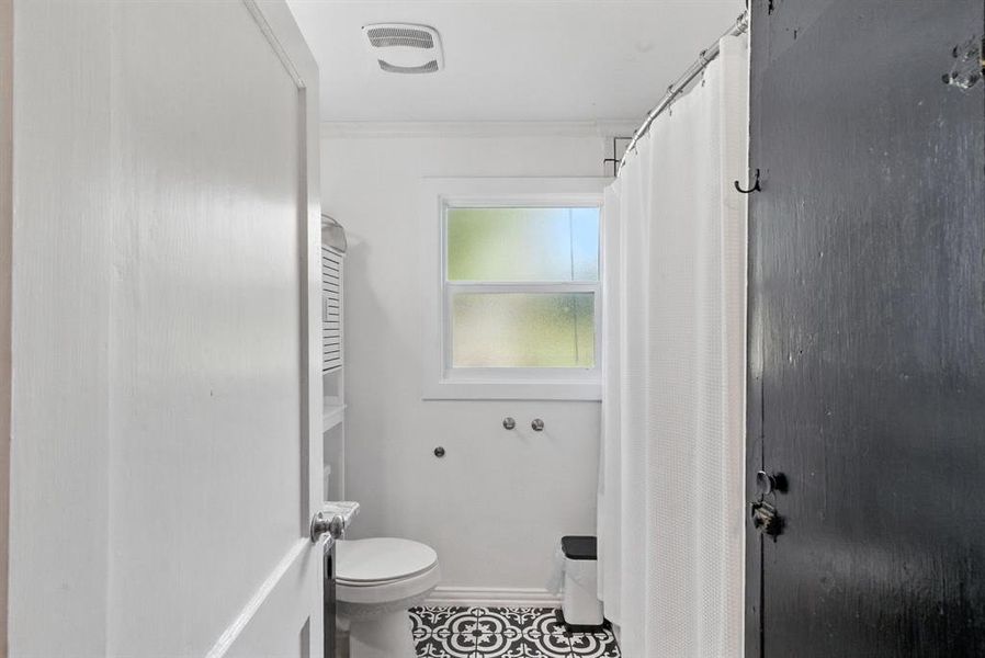 Bathroom featuring tile patterned floors and curtained shower Bathroom featuring tile patterned floors and curtained shower