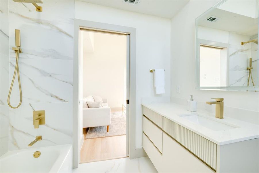 Bathroom with vanity, tiled shower / bath, and hardwood / wood-style floors