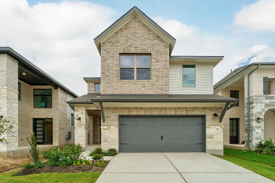 Front exterior of a new home in Parmer Ranch, Georgetown, TX, highlighting curb appeal (Image 21). Front exterior of a new home in Parmer Ranch, Georgetown, TX, highlighting curb appeal (Image 21).