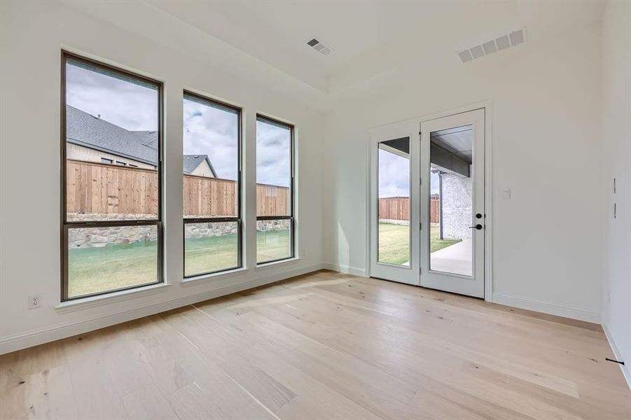 Unfurnished room with light hardwood / wood-style flooring