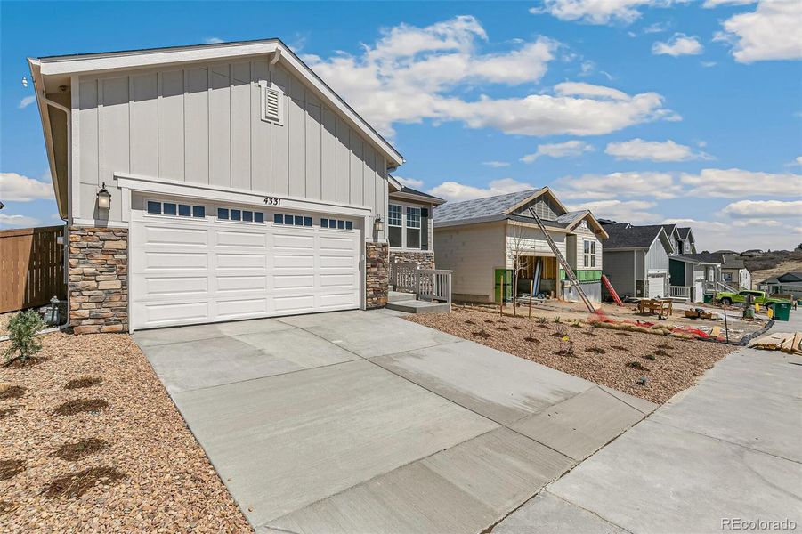 Front exterior of a new home in Terrain Oak Valley, Castle Rock, CO, highlighting curb appeal (Image 23). Front exterior of a new home in Terrain Oak Valley, Castle Rock, CO, highlighting curb appeal (Image 23).