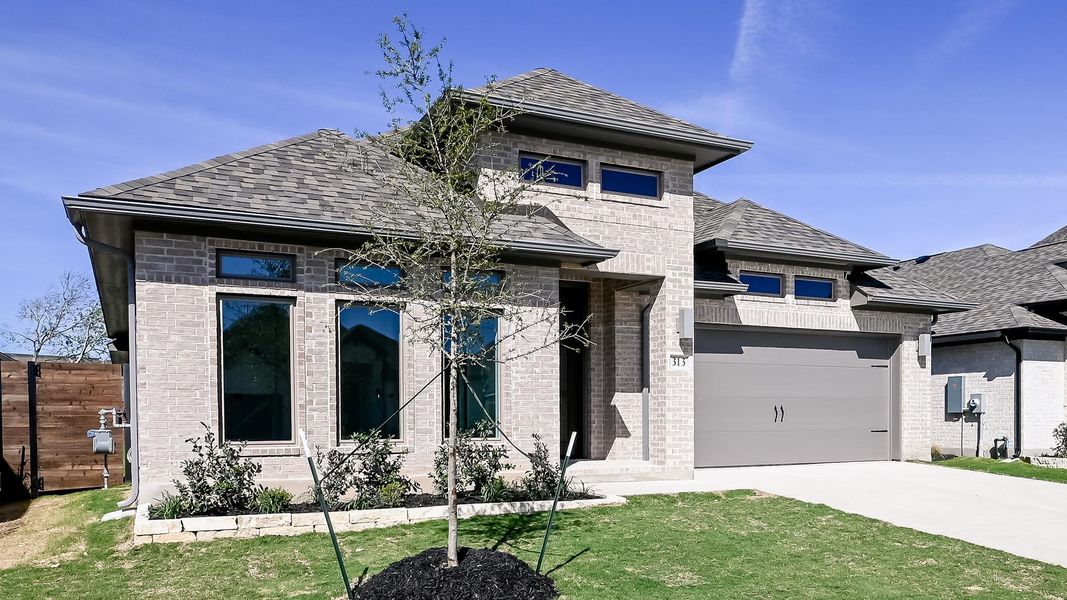 Front exterior of a new home in Juniper Springs, Lockhart, TX, highlighting curb appeal (Image 21).
