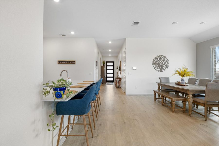 Dining space featuring light wood finished floors, healthy amount of natural light, and recessed lighting Dining space featuring light wood finished floors, healthy amount of natural light, and recessed lighting