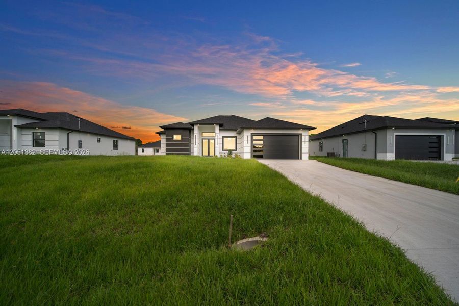 Front exterior of a new home in , Lehigh Acres, FL, highlighting curb appeal (Image 24). Front exterior of a new home in , Lehigh Acres, FL, highlighting curb appeal (Image 24).