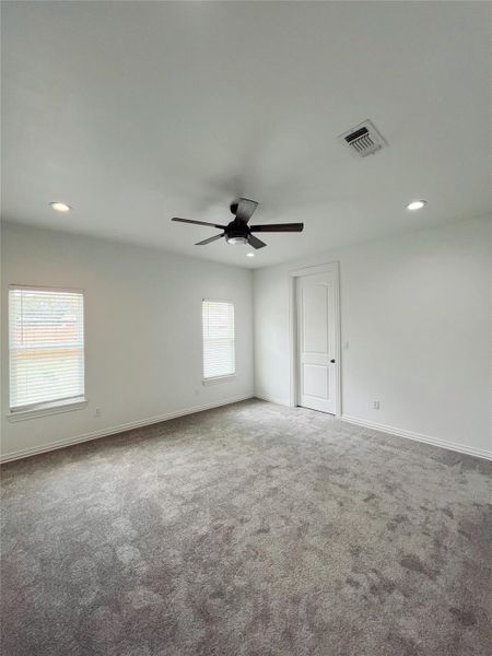 Carpeted spare room with baseboards, a ceiling fan, visible vents, and recessed lighting Carpeted spare room with baseboards, a ceiling fan, visible vents, and recessed lighting