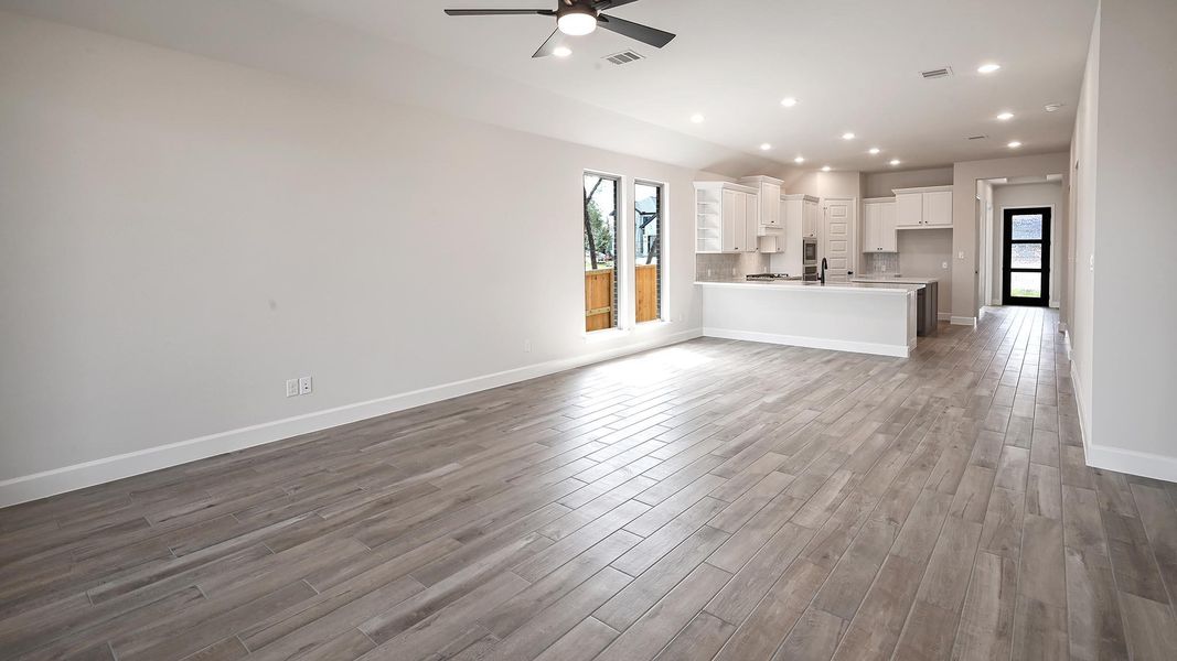 Unfurnished living room with recessed lighting, dark wood-style floors, and ceiling fan