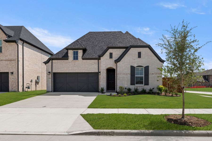Front exterior of a new home in Lily Creek at Sutton Fields, Aubrey, TX, highlighting curb appeal (Image 1). Front exterior of a new home in Lily Creek at Sutton Fields, Aubrey, TX, highlighting curb appeal (Image 1).