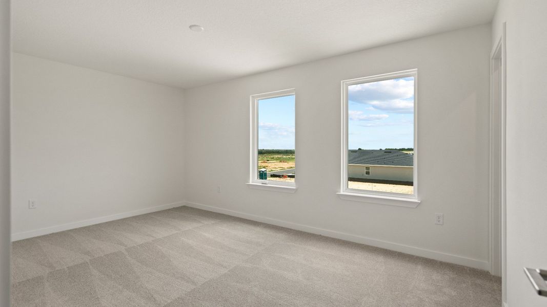 Spacious second bedroom with soft carpeting and great natural light—ideal for guests, kids, or a cozy retreat