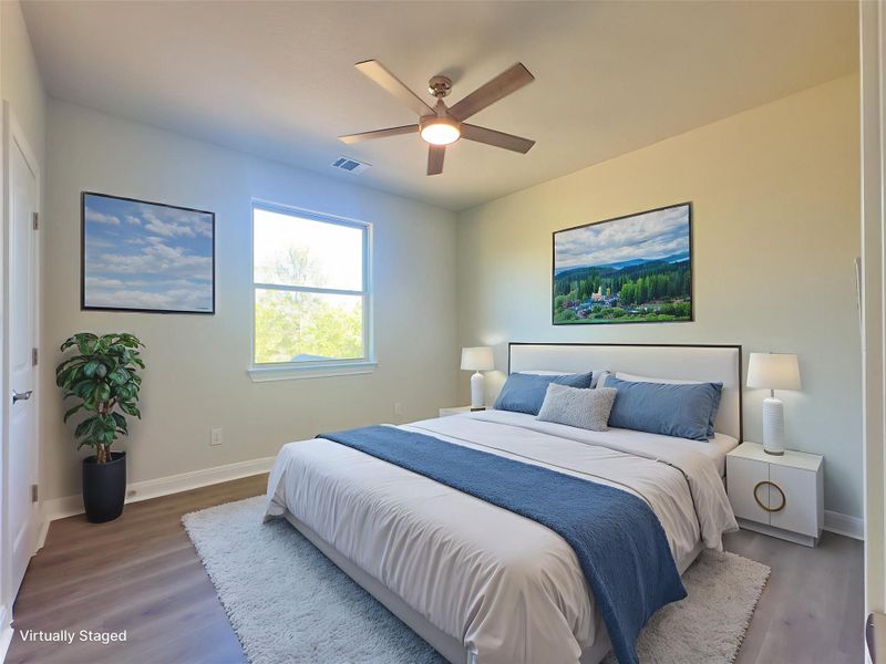 Bedroom with wood finished floors and a ceiling fan Bedroom with wood finished floors and a ceiling fan