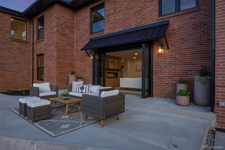 New concrete front patio with folding doors to the living room