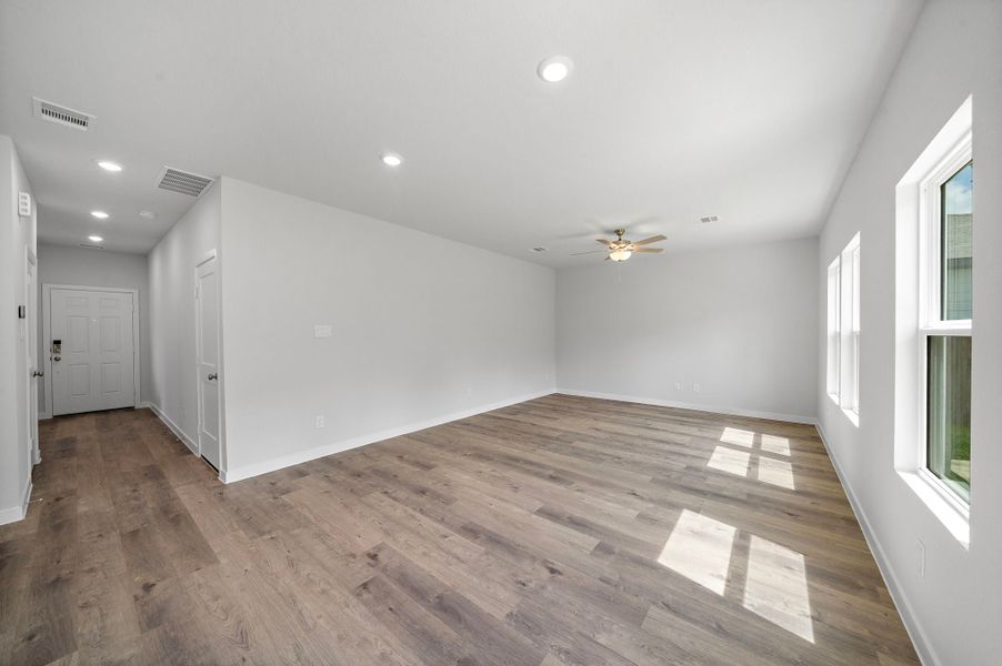 A room with a wood floor and white walls.