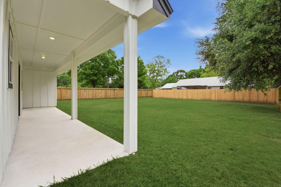 Large backyard fully fenced with covered patio and double gate