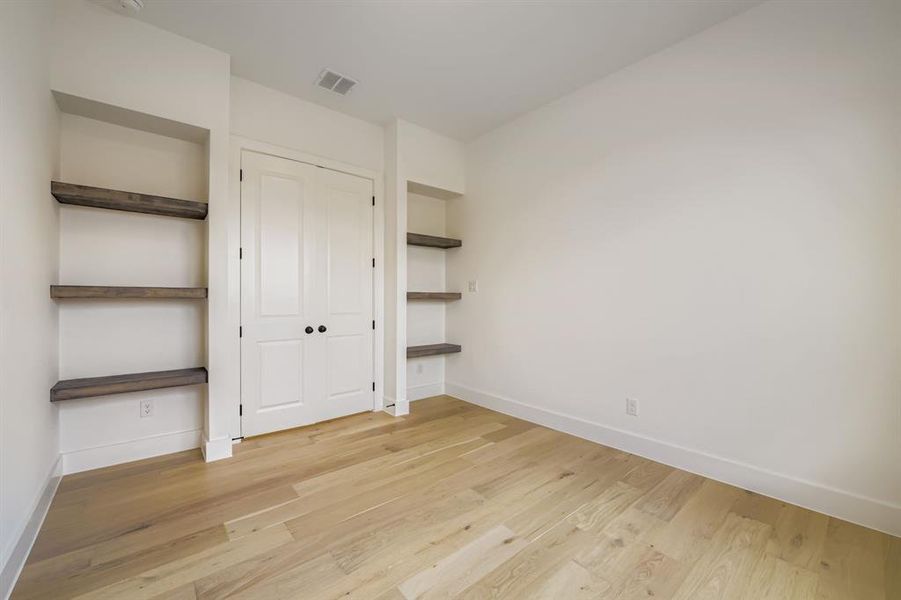 Unfurnished bedroom featuring light wood-style flooring and a closet Unfurnished bedroom featuring light wood-style flooring and a closet
