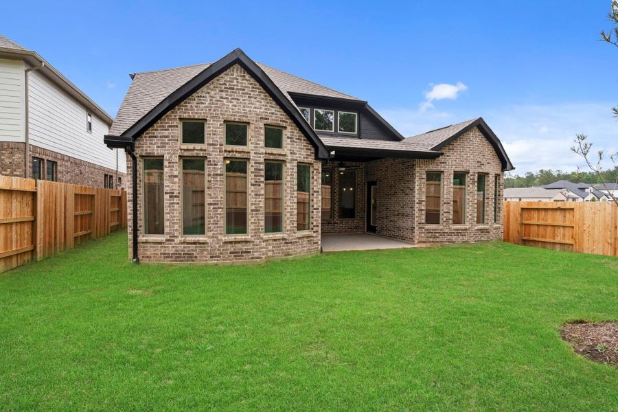 Exterior details and patio area of a home in Wildtree, Magnolia (Image 23).