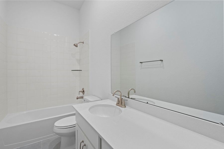 The secondary bath features tile flooring, white cabinetry and light countertops and a shower/tub combo. Perfect for accommodating any visiting family and friends. The secondary bath features tile flooring, white cabinetry and light countertops and a shower/tub combo. Perfect for accommodating any visiting family and friends.