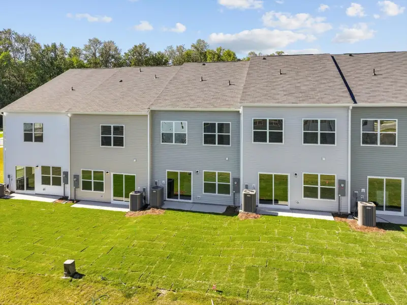 Exterior details and patio area of a home in West Main Townhomes, Sanford (Image 3).