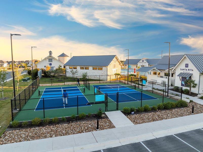 View of tennis court with a residential view