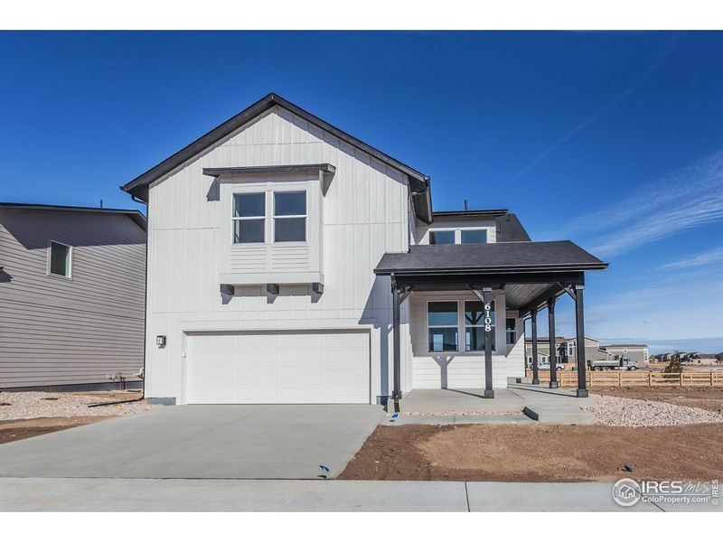 Front exterior of a new home in Trailside Story Collection - Single Family Homes, Timnath, CO, highlighting curb appeal (Image 26). Front exterior of a new home in Trailside Story Collection - Single Family Homes, Timnath, CO, highlighting curb appeal (Image 26).