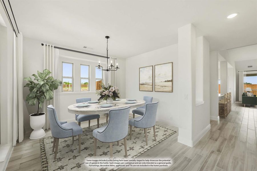 Dining room with oval table, six blue chairs, chandelier, and wood-look floors Dining room with oval table, six blue chairs, chandelier, and wood-look floors