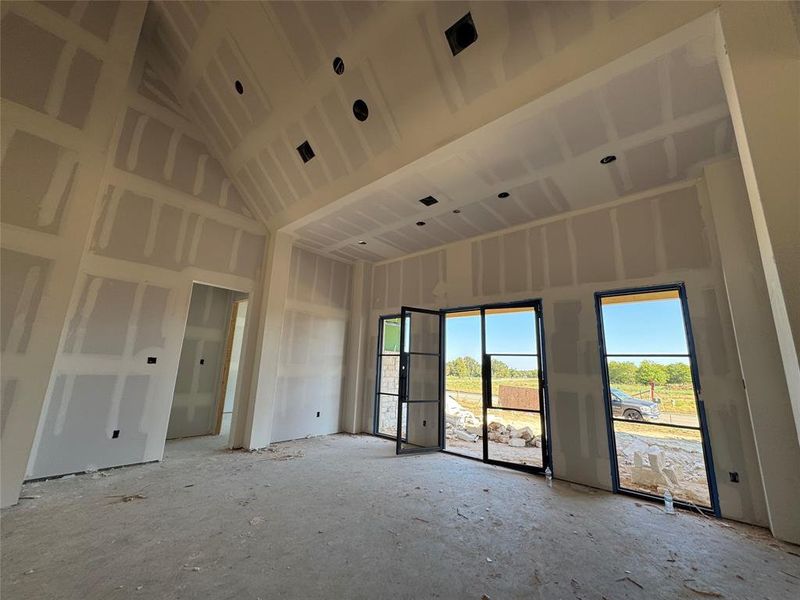 Unfurnished room featuring a towering ceiling