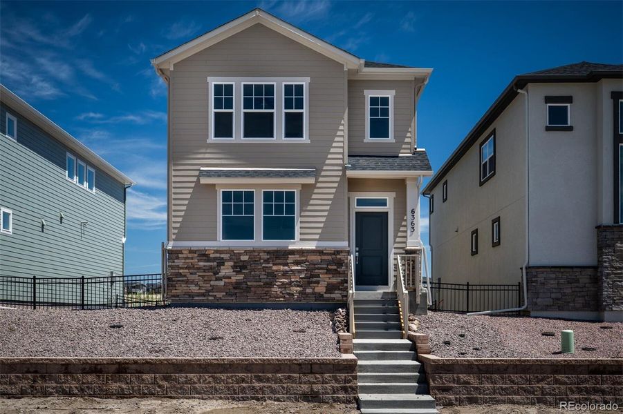 Front exterior of a home in the Revel Crossing at Wolf Ranch – The Ascent Collection community, located in Colorado Springs, CO (Image 4).