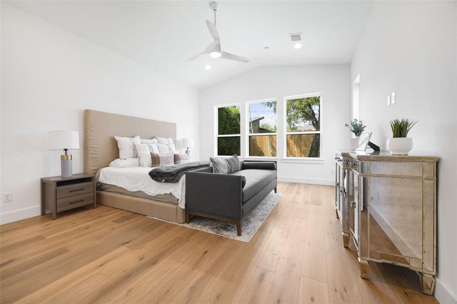 Bedroom featuring lofted ceiling, light wood-style flooring, ceiling fan, and recessed lighting Bedroom featuring lofted ceiling, light wood-style flooring, ceiling fan, and recessed lighting