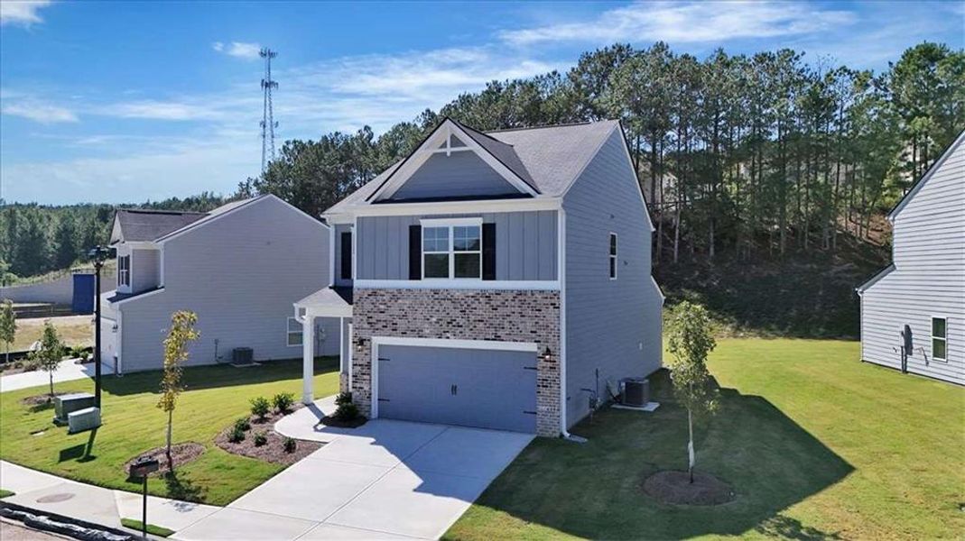 Front exterior of a new home in The View at Groover's Lake, Lithia Springs, GA, highlighting curb appeal (Image 19). Front exterior of a new home in The View at Groover's Lake, Lithia Springs, GA, highlighting curb appeal (Image 19).