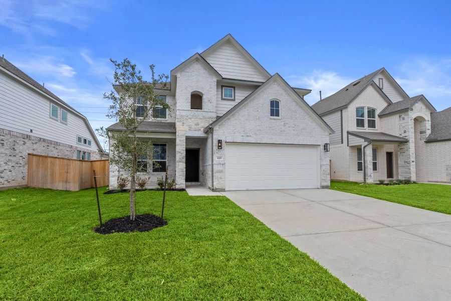 Front exterior of a new home in Huntington Place, Rosharon, TX, highlighting curb appeal (Image 1). Front exterior of a new home in Huntington Place, Rosharon, TX, highlighting curb appeal (Image 1).