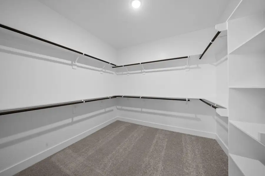 A stylish walk-in closet awaits, providing ample storage for your wardrobe and a little extra room for those cherished items. REPRESENTATIVE PHOTO