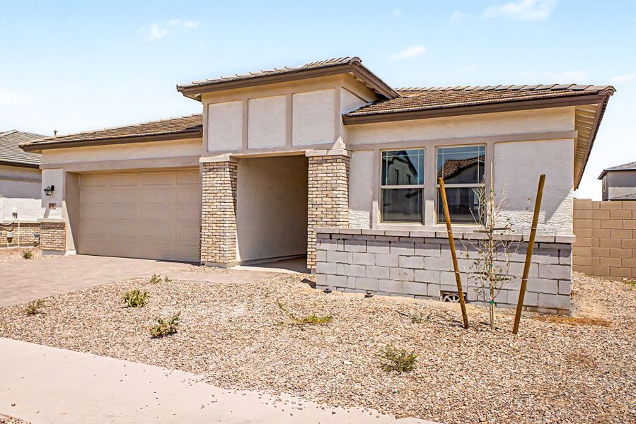 Front exterior of a new home in North Creek, Queen Creek, AZ, highlighting curb appeal (Image 2). Front exterior of a new home in North Creek, Queen Creek, AZ, highlighting curb appeal (Image 2).