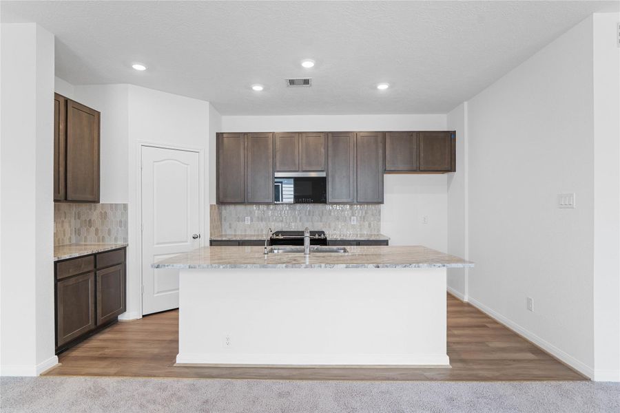 This spacious kitchen has it all—ample storage, generous counter space, and a layout that truly makes it the heart of the home.