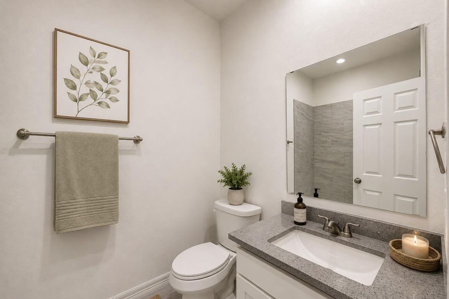 Secondary full bathroom complimented by quartz countertops and practical design