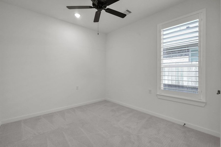 The other secondary bedroom with plantation shutters.