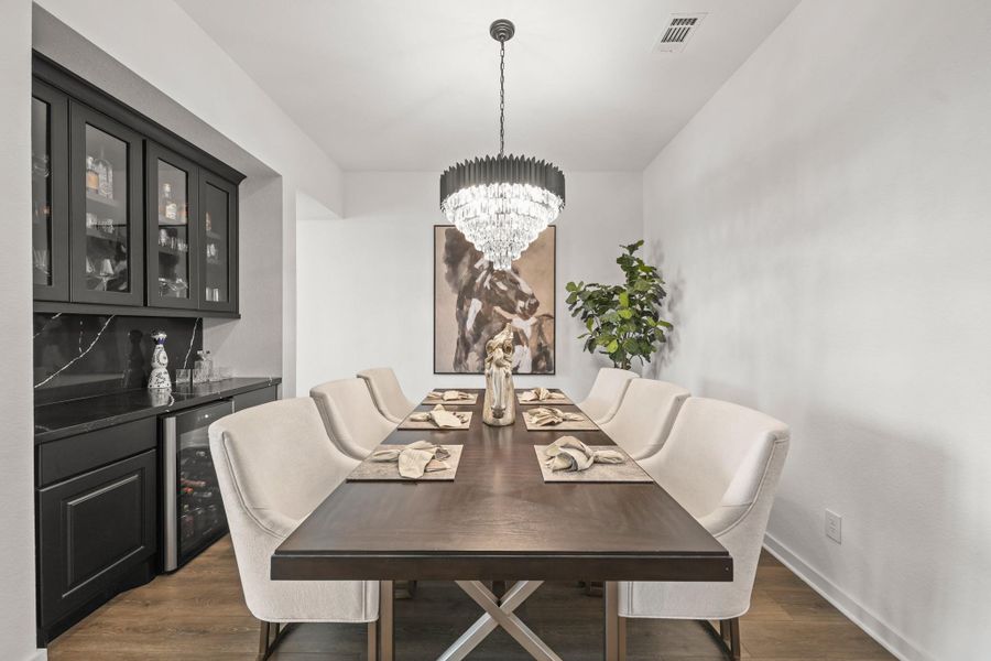 The built-in butler’s pantry includes a wine refrigerator, Quartz counters with matching back splash and upper glass display cabinets offering both style and convenience for dinner parties and entertaining.
