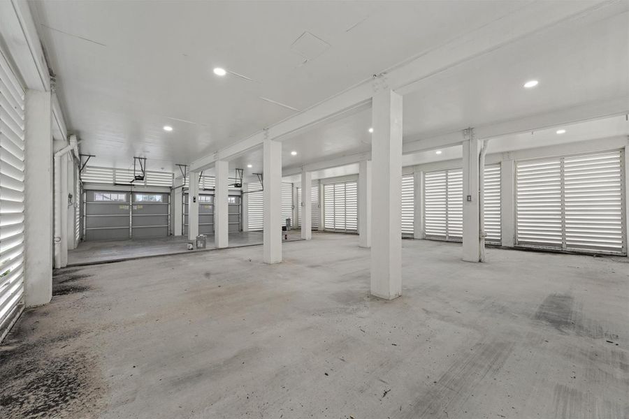 Expansive 4 car tandem garage and storage area features breakaway walls, concrete floors, and room for boats, golf carts, and more. Expansive 4 car tandem garage and storage area features breakaway walls, concrete floors, and room for boats, golf carts, and more.