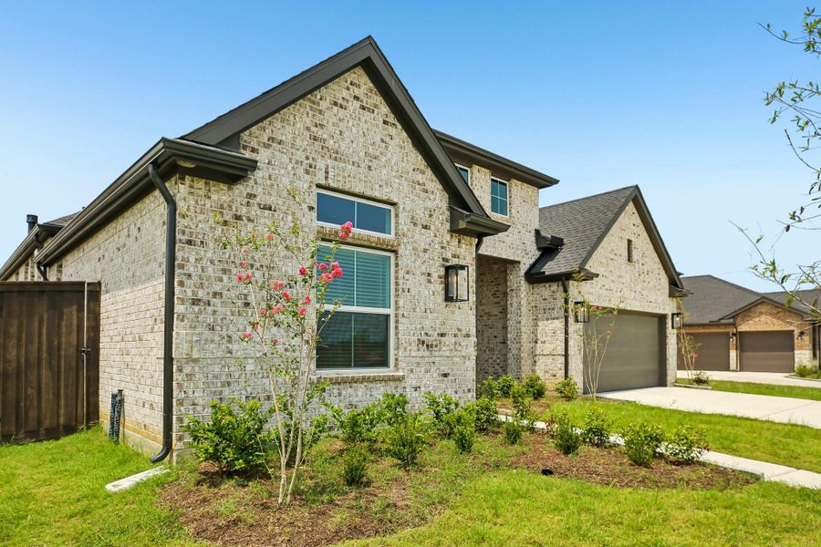Front exterior of a new home in Riceland 60',65',70', Old River-Winfree, TX, highlighting curb appeal (Image 24).