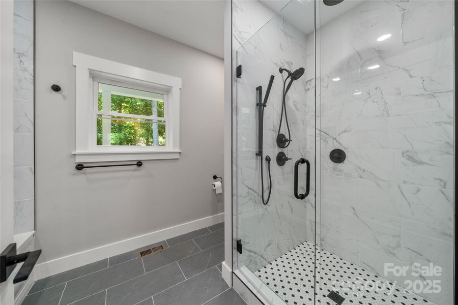 Gleaming primary spa bath with heated floors!