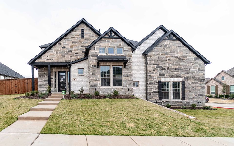 Front exterior of a new home in Sonoma Verde, Heath, TX, highlighting curb appeal (Image 1). Front exterior of a new home in Sonoma Verde, Heath, TX, highlighting curb appeal (Image 1).
