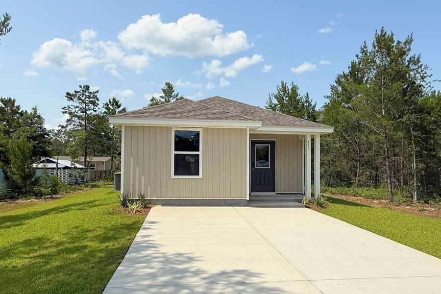 A small building with a driveway. A small building with a driveway.