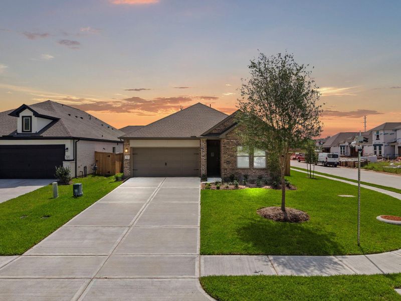 Front exterior of a new home in Windrose Green, Angleton, TX, highlighting curb appeal (Image 2). Front exterior of a new home in Windrose Green, Angleton, TX, highlighting curb appeal (Image 2).