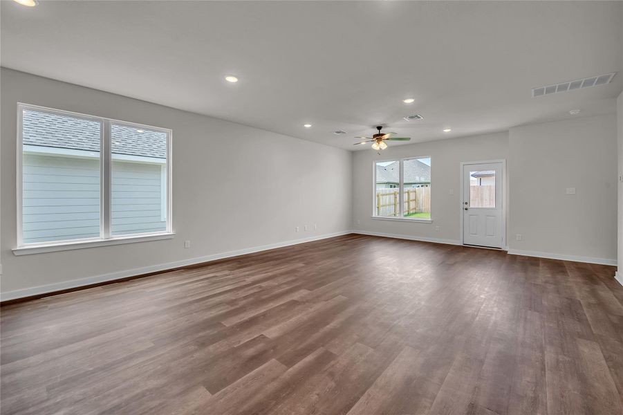 Unfurnished living room featuring recessed lighting, dark wood-style flooring, and a ceiling fan Unfurnished living room featuring recessed lighting, dark wood-style flooring, and a ceiling fan